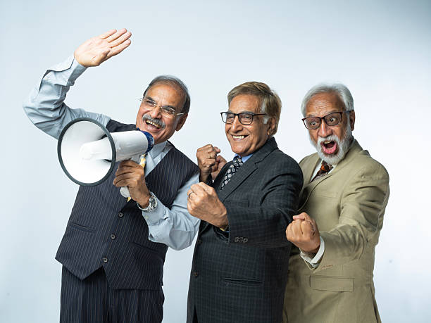 istock Elderly partners making announcement on white background 2249584423