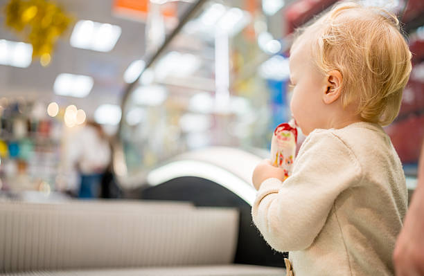 istock Toddler Eating Puree from a Pouch in a Bright Indoor Setting 2249584671