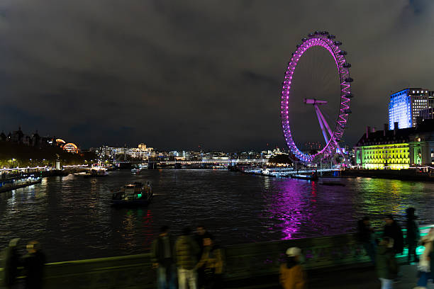 London United Kingdom on November  20, 2025. The London eye ferry s wheel from the banks of the Thames river. Night view.