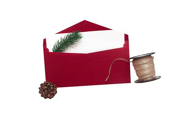 Red envelope with white card, pine branch, cone and twine, isolated on white background, festive and natural