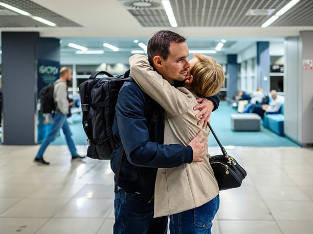 istock Young man returning from an international trip hugs his mother 2249592878