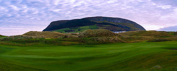 Knocknarea Mountain peak, or Cnoc na Riabh in Irish, also called the Hill of Kings or Hill of Maeve, rises above the Coolera Peninsula near Strandhill in Ireland, a tranquil winter landscape over the green.