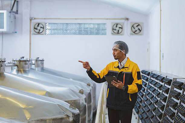 istock Winemaker working in modern large winery factory liquor drink industry quality. Staff inspecting wine in modern wine factory. Winery manufacturing quality control. Alcohol and wine winemaking process 2249599174