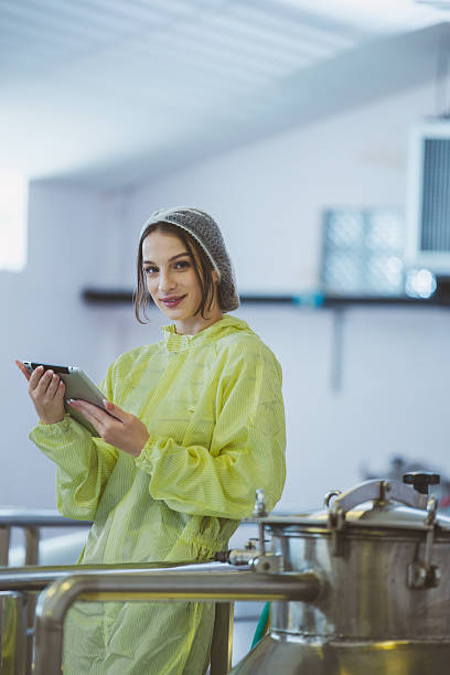 istock Winemaker working in modern large winery factory liquor drink industry quality. Staff inspecting wine in modern wine factory. Winery manufacturing quality control. Alcohol and wine winemaking process 2249599176