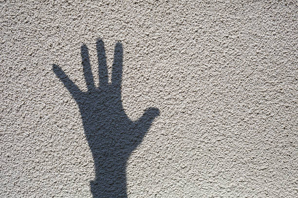istock Shadow from the hand on the pavement. Shadow play on a sunny day 2249601737