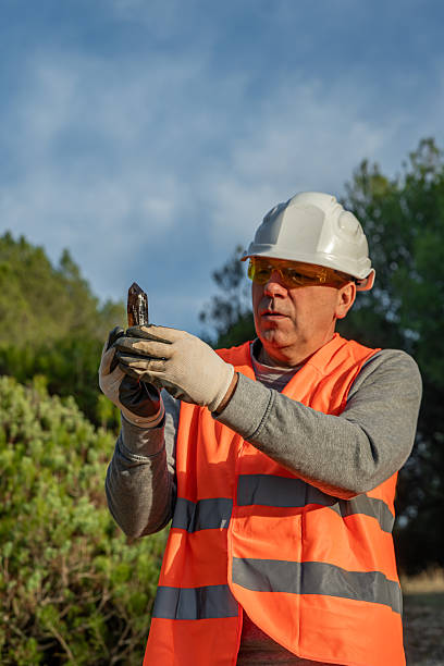 istock Geologist showing a citrine quartz crystal, extracted from an open-pit quarry. 2249602603