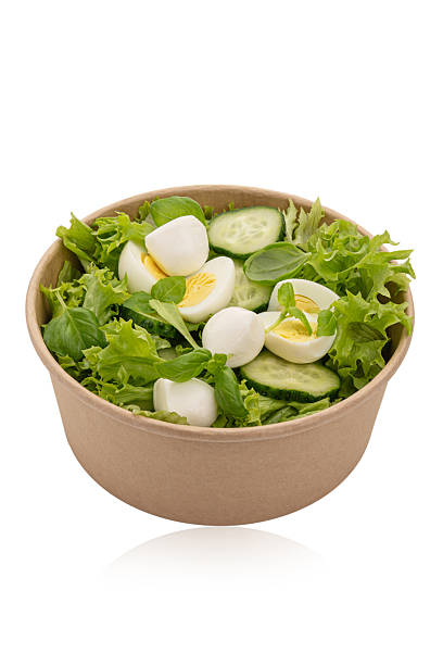 istock Green salad with eggs and cheese on a white isolated background 2249602699
