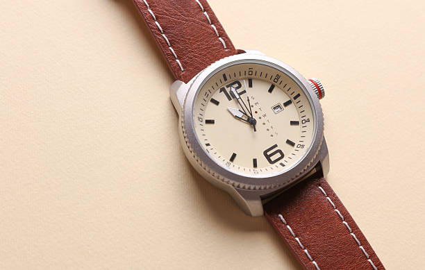 istock Men's wristwatch with leather strap on beige background 2249607162
