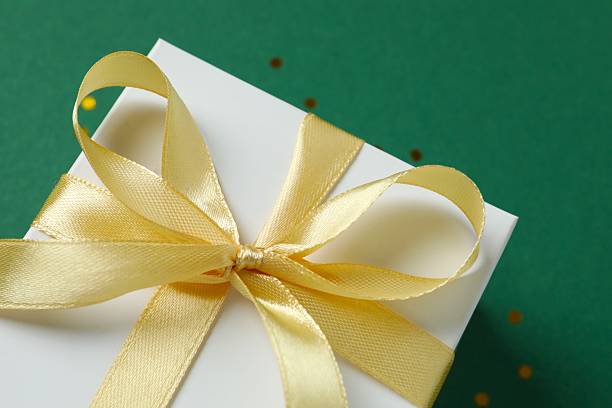 istock Festive gift box on green background, close-up view 2249607243