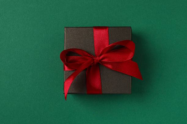 istock Top view of festive gift box on color background, close-up view 2249607258