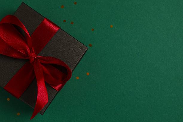 istock Festive gift box on color background, close-up view 2249607260