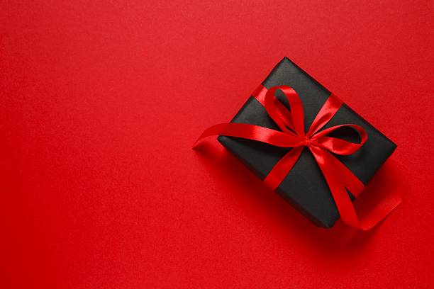istock Gift box tied with bow on color background 2249610144