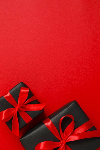 istock Beautiful gift boxes tied with bows on black background 2249610242