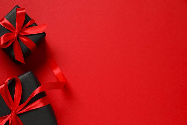 istock Beautiful gift boxes tied with bows on black background 2249610244