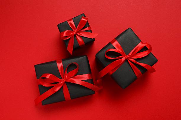 istock Top view of gift boxes tied with bows on red background 2249610287