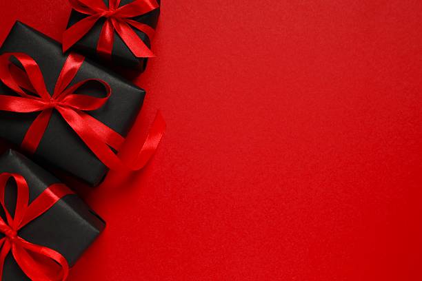 istock Top view of gift boxes tied with bows on black background 2249610335