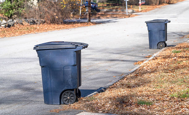 blue trash can on the residential street