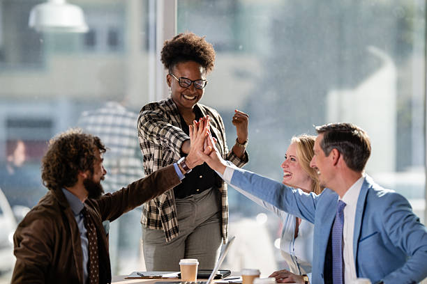 istock Business team colleagues celebrating success with a high five 2249611441