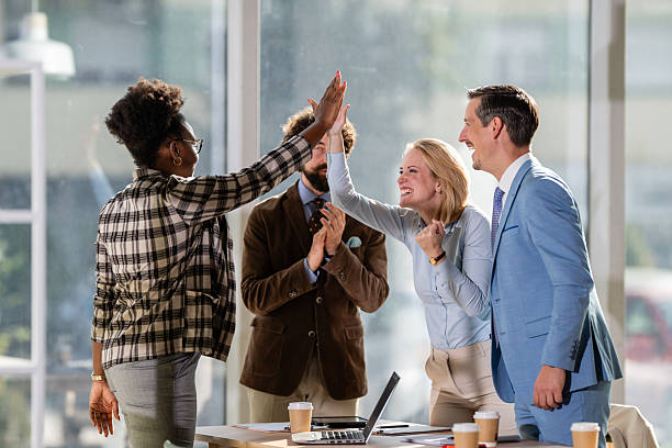 istock Diverse business team celebrating success with high five 2249611559