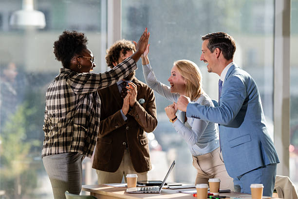 istock Diverse business team celebrating success with high five 2249611592