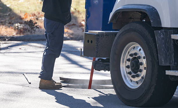 istock worker beside working truck check underground utility 2249612096