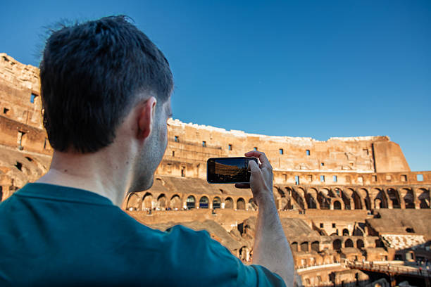 istock Person capturing Colosseum architecture on smartphone in Rome 2249612340