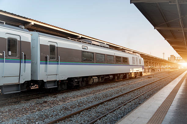 istock A train rests on the tracks at a quiet station as the sun rises, casting warm light and creating a serene morning scene. The station is empty, evoking a sense of tranquility 2249615211