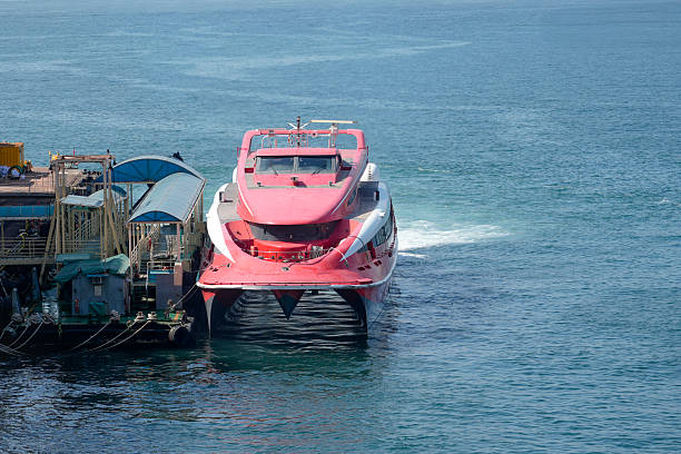 A modern passenger transport catamaran on the edge of Ponta D'areia beach, in the city of São Luis, Maranhão, northeast Brazil, with a blurred background