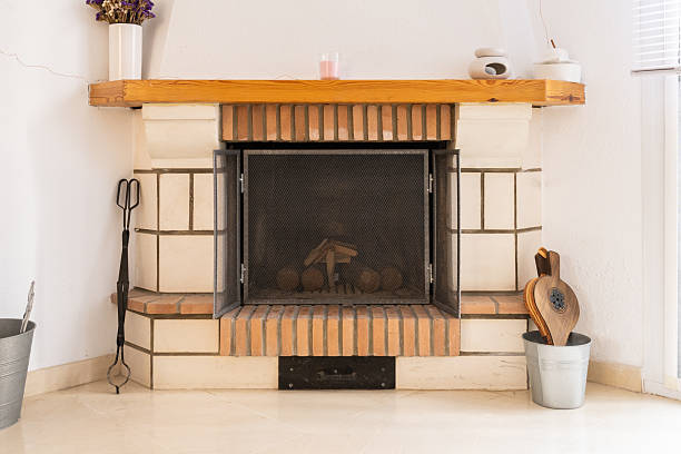 istock Cozy indoor brick fireplace with logs and tools 2249617196