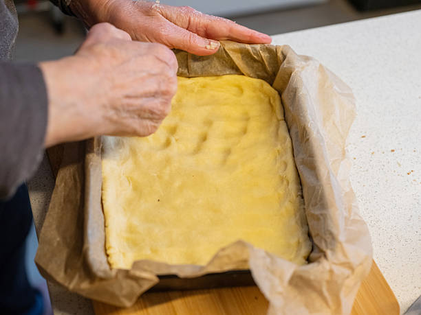 istock Hands preparing dough in baking dish for delicious homemade dessert 2249618513