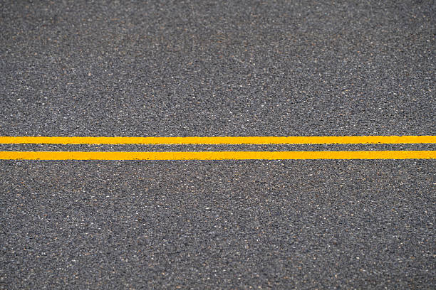 istock double yellow line on the road surface 2249619827