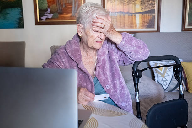 istock Senior woman experiencing stress using credit card online 2249622199