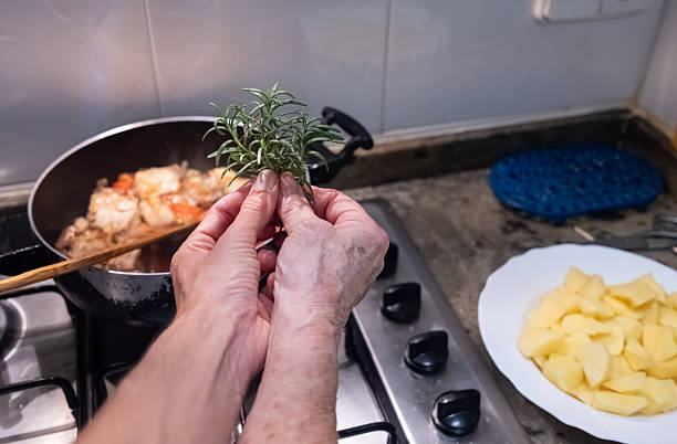 Senior woman holding fresh rosemary for home cooking