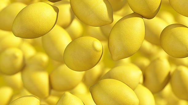 Yellow lemons falling gently against a black background creating a vibrant, lively display