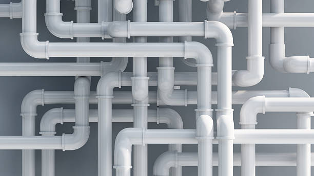 istock Different types of white plumbing pipes arranged in a complex layout on a gray background 2249622662