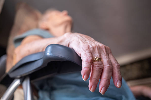 istock Senior woman's hand resting on armchair after death 2249622720