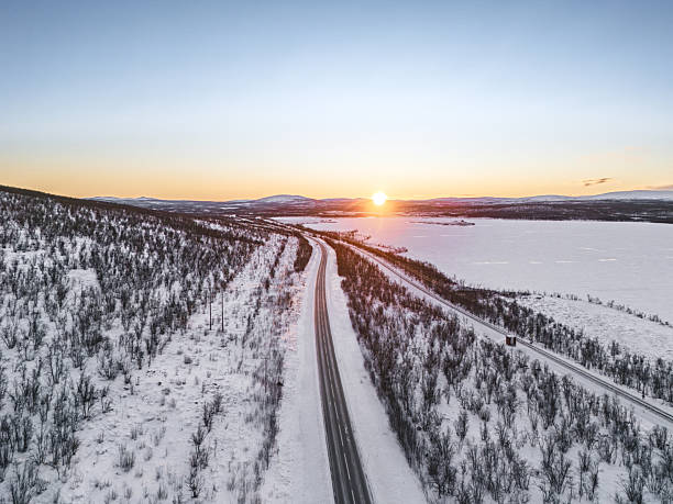 istock Road E10 and railroad between Kiruna and Narvik, during the arctic winter, at noon with the sun barely above the horizon, Sweden 2249624932