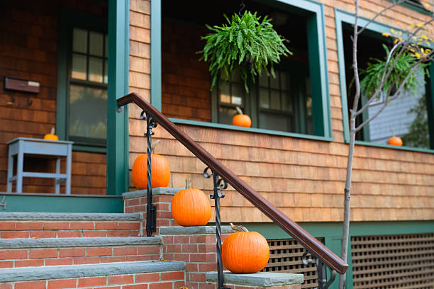 istock Porch decorated with bright orange pumpkins on brick steps 2249625460