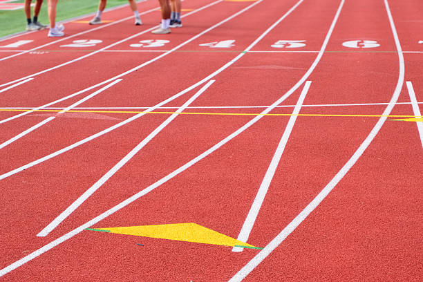 istock Unrecognizable athletes gather on a red running track 2249625528