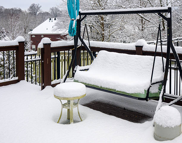 Backyard swing and tables covered with fresh snow six inches deep