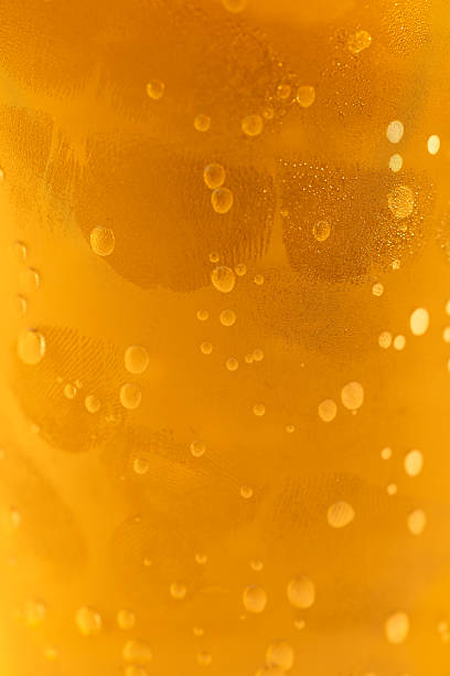 Bubbles on the wall of a glass from a carbonated drink