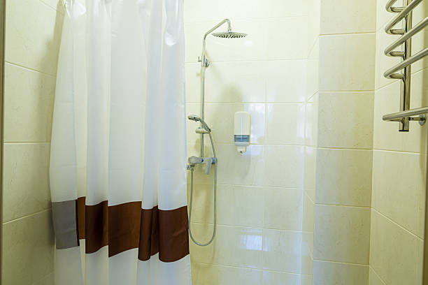 istock Bright bathroom with shower, shower head, light tile 2249632770