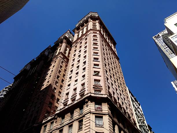 istock Old building seen from below with blue sky in the background. 2249633375