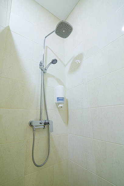 istock Bright bathroom with shower, shower head, light tile 2249634677