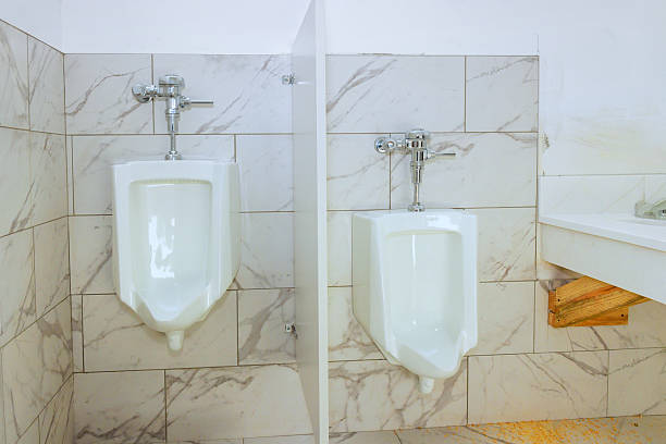 istock Modern restroom design featuring white urinals in clean minimalistic space 2249635158