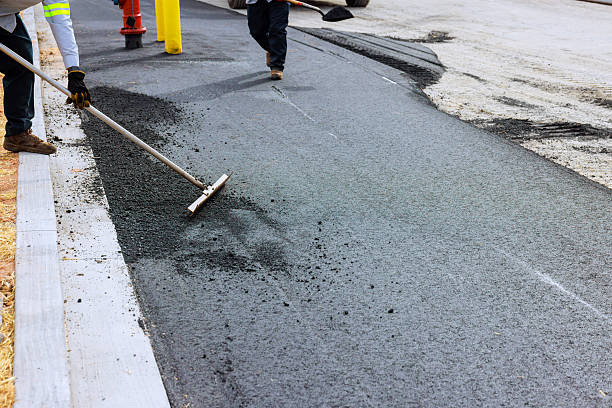 istock Workers laying asphalt on new road in construction area 2249635163