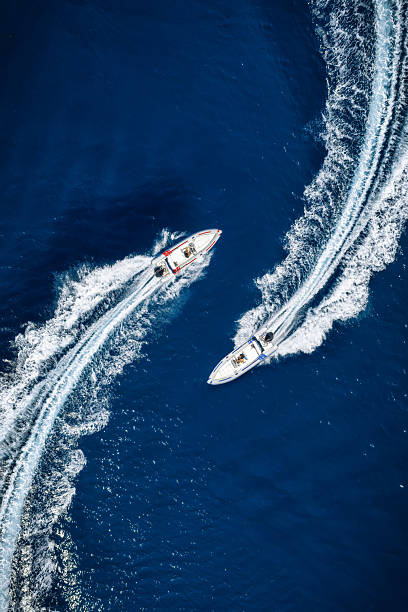 Aerial overhead view of two RIB speedboats racing over the ocean