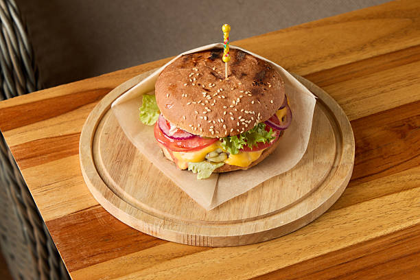 istock Rustic sandwich on natural setting, Traditional beef burger with fresh ingredients displayed 2249635400