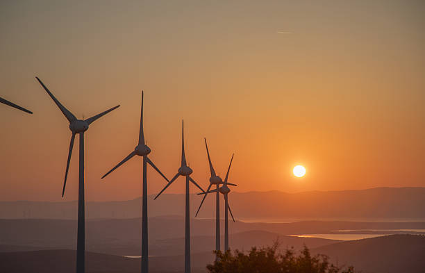 istock Wind Turbines Sunset — Renewable Energy Landscape at Dusk 2249636180