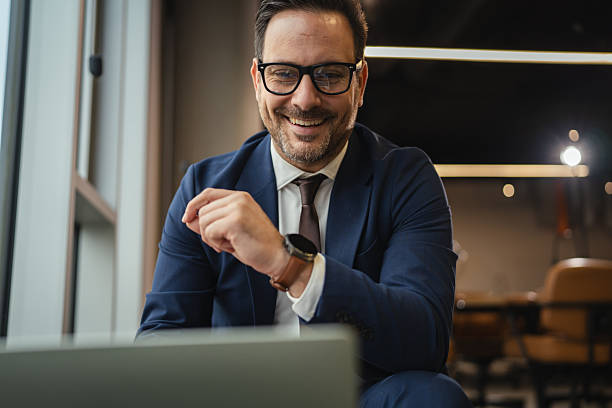istock Happy businessman smiling during video call in modern office 2249638288
